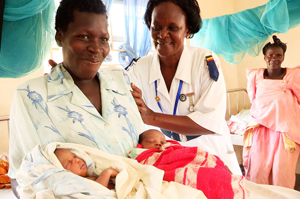 Habiba with a client and her newborn twins