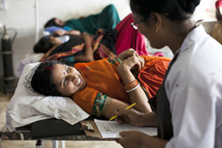 Health worker and client in India
