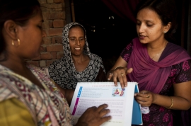 © Photo by Trevor Snapp, courtesy of IntraHealth International. Doctor teaching about breastfeeding and nutrition in Pandoli village in India in 2011.