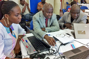 Kayode Odusote (center) works with colleagues at a workshop in Togo